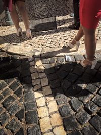 Low section of people standing on footpath