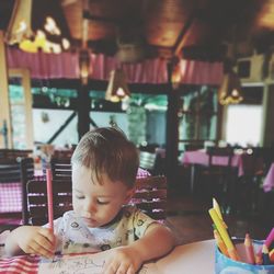 Cute boy looking at table