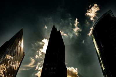 Low angle view of buildings against cloudy sky