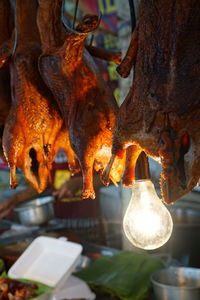 Close-up of meat hanging on barbecue