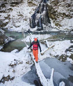 High angle view of man walking on driftwood