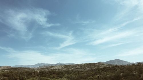 Scenic view of mountains against cloudy sky