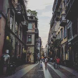 Street amidst buildings in city against sky