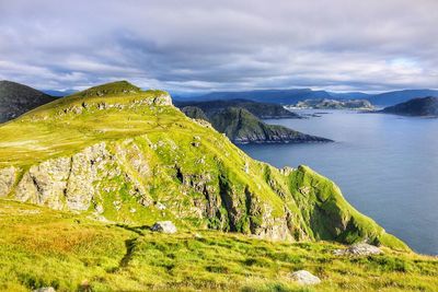 Scenic view of mountains against cloudy sky