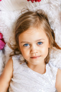 Portrait of cute girl lying on bed