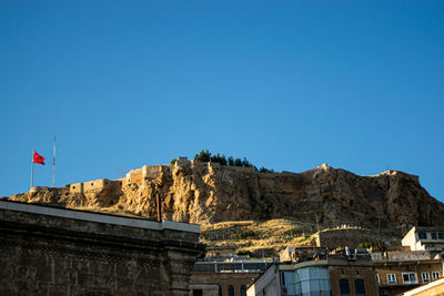 Low angle view of buildings against clear blue sky