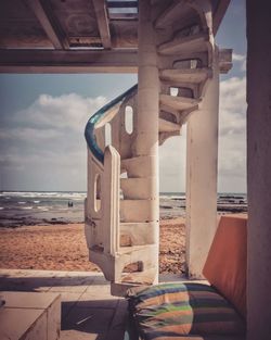 Built structure on beach against sky