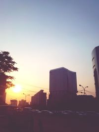 Buildings in city at sunset