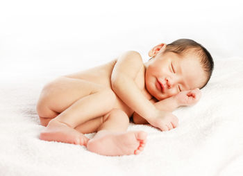 Baby girl sleeping on bed