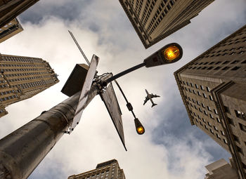 Low angle view of street light and buildings against sky