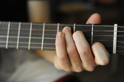 Close-up of hands playing guitar