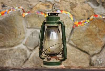 Close-up of light bulb hanging on wall