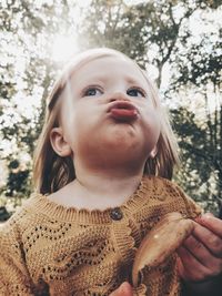 Close-up portrait of a girl in forest