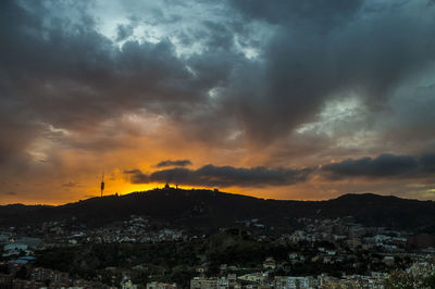 Scenic view of townscape against sky during sunset