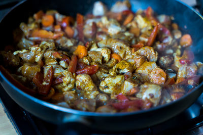 Chicken with vegetables. process of cooking. frying pan with vegetables and chicken meat