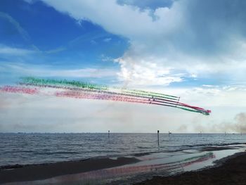 Scenic view of beach against sky during an italian air show