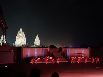 View of illuminated buildings against sky at night