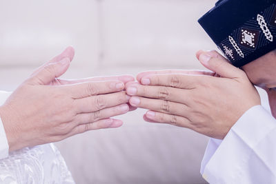 Midsection of couple holding hands