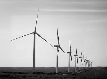 Wind turbines against sky