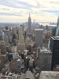 View of cityscape against cloudy sky