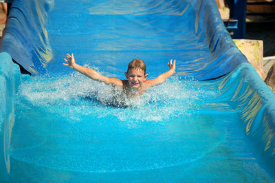 Boy on water slide