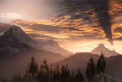 Scenic view of snowcapped mountains against sky during sunset