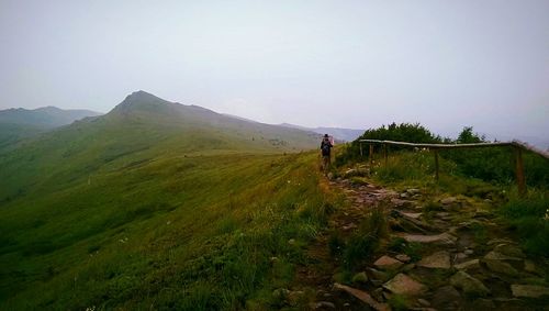 Man standing on landscape against sky