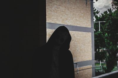 Low section of person sitting by window