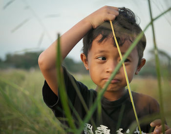 Close-up of young boy looking away while playing