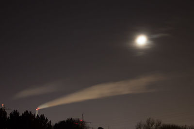 Low angle view of silhouette trees against sky at night