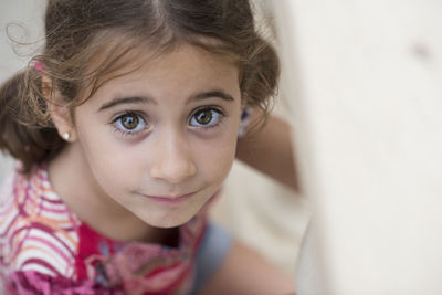 Portrait of cute girl sitting at home