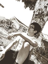 Low angle portrait of young man against built structure