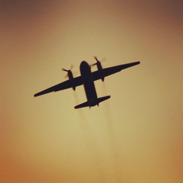 airplane, air vehicle, transportation, mode of transport, low angle view, flying, silhouette, mid-air, sunset, travel, sky, copy space, public transportation, journey, orange color, outdoors, on the move, helicopter, commercial airplane, no people