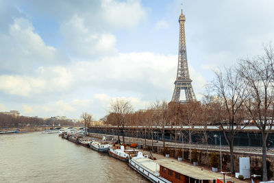 Ships in seine river with eiffel tower in background