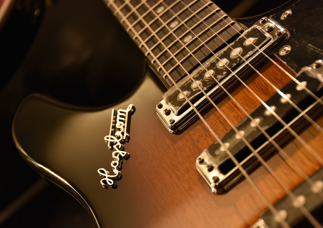 indoors, musical instrument, music, guitar, musical instrument string, musical equipment, arts culture and entertainment, high angle view, close-up, metal, acoustic guitar, still life, selective focus, string instrument, technology, table, focus on foreground, no people, piano, piano key