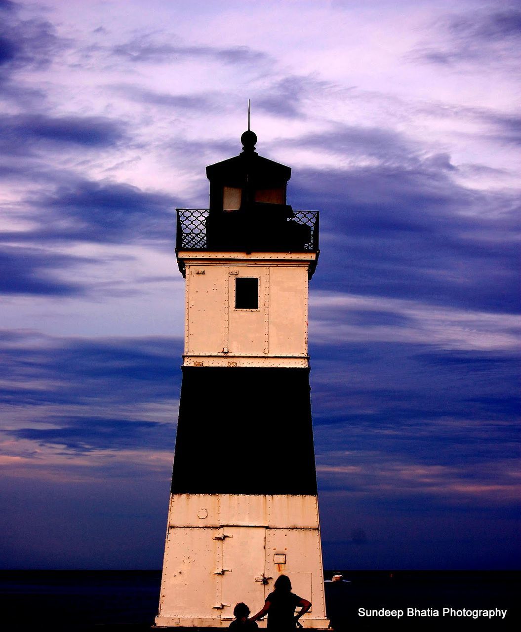 sky, sea, cloud - sky, horizon over water, built structure, water, architecture, cloud, building exterior, men, lifestyles, beach, cloudy, lighthouse, leisure activity, unrecognizable person, outdoors, nature