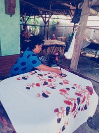 Woman sitting on table