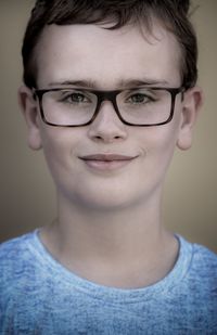 Close-up portrait of smiling boy in eyeglasses