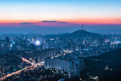 High angle view of illuminated cityscape against sky at night