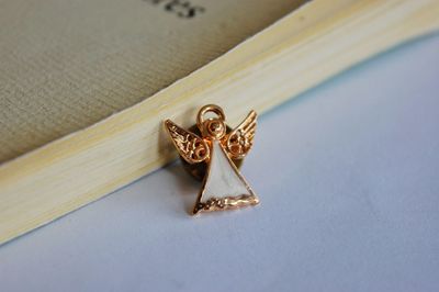 High angle view of jewelry with book on table