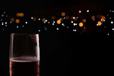 Close-up of wine glass against black background