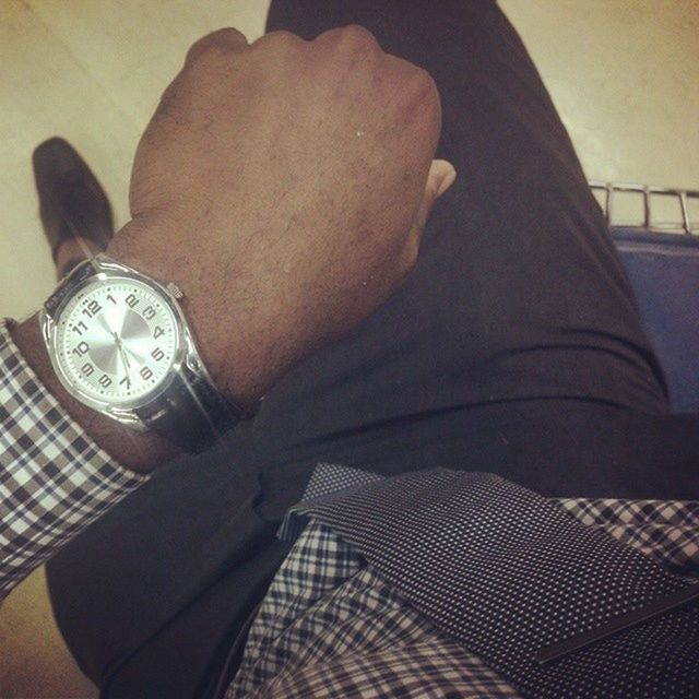 indoors, lifestyles, leisure activity, person, personal perspective, part of, men, sitting, close-up, high angle view, relaxation, casual clothing, low section, wristwatch, holding