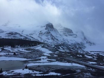 Scenic view of snow covered mountains against sky