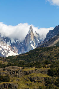 Scenic view of mountains against cloudy sky