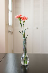 Close-up of flower vase on table at home