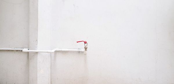 Close-up of pipe on white wall