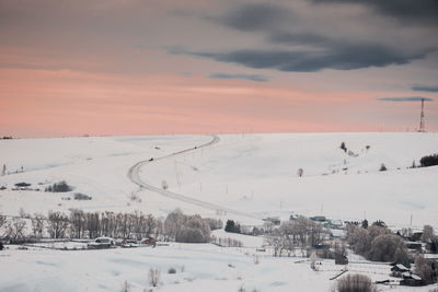 Scenic view of field against sky during winter
