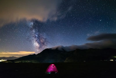 Scenic view of mountains against sky at night