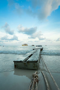 Fishing boat in sea against sky