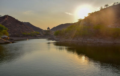 Scenic view of lake against sky during sunset